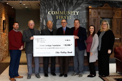 oversized donation check being presented to a group of people